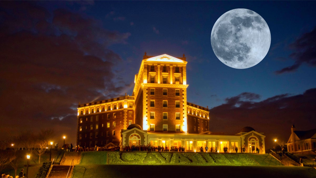 A distant front view of a historic hotel with a Halloween theme.